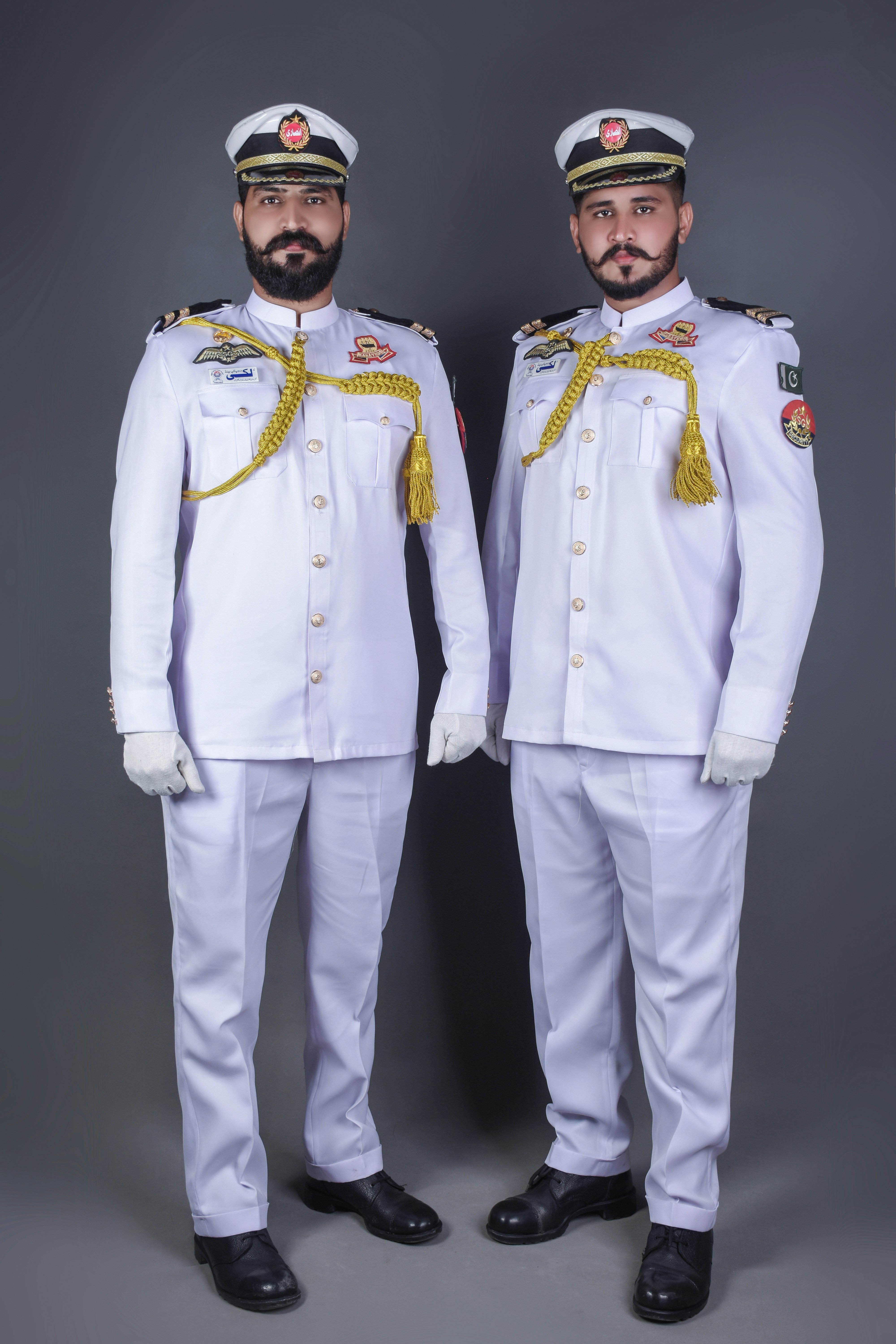 two men in military uniforms standing next to each other