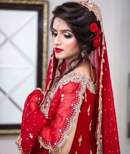 a woman in a red dress with a red rose in her hair