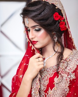 a woman in a red dress with a flower in her hair