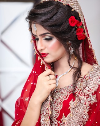a woman in a red dress with a flower in her hair