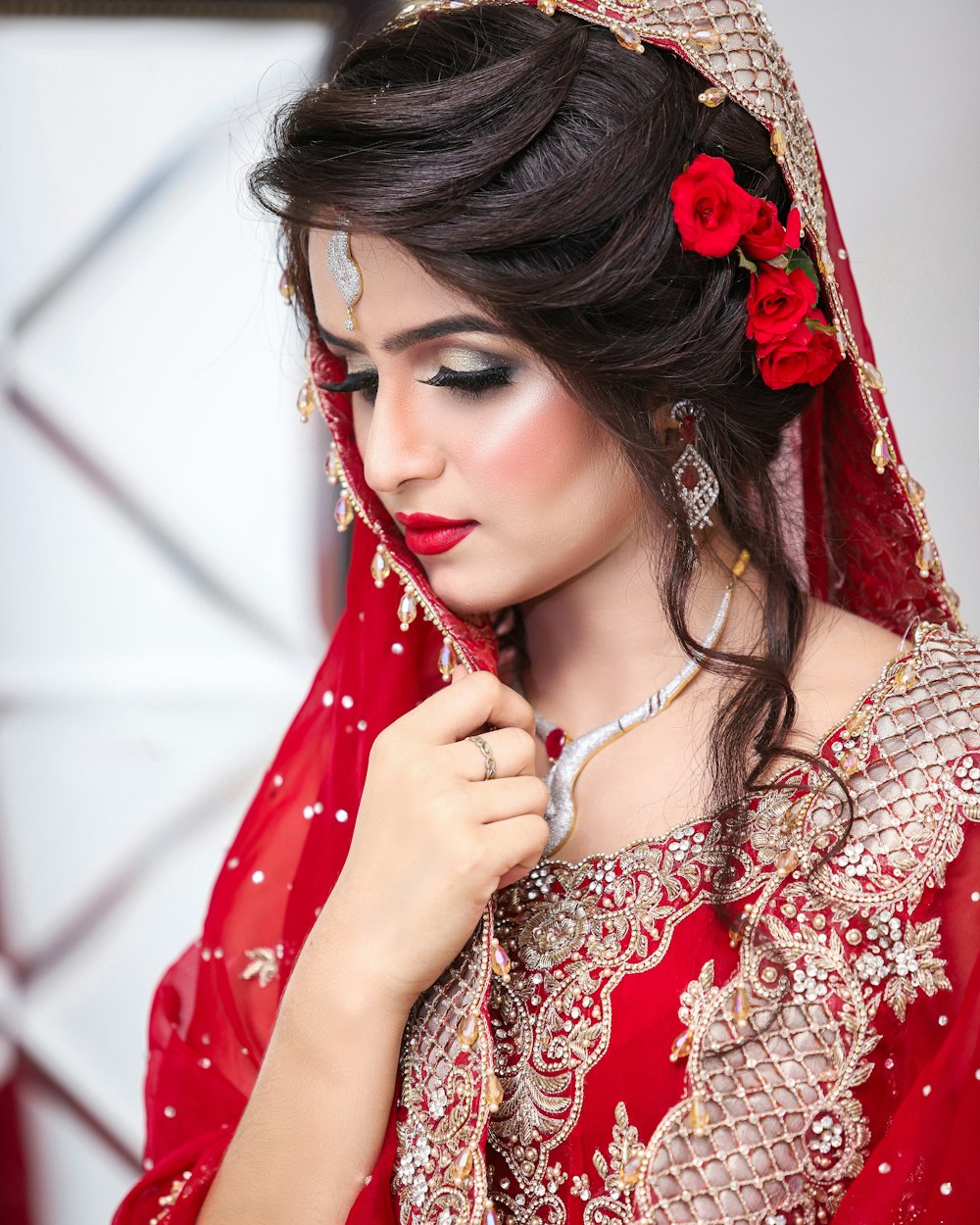 a woman in a red dress with a flower in her hair