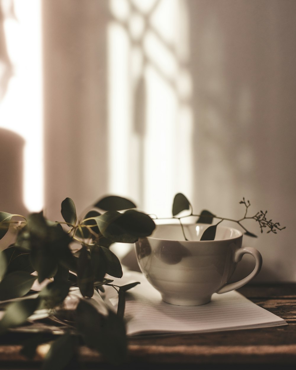 a cup of coffee sitting on top of a wooden table