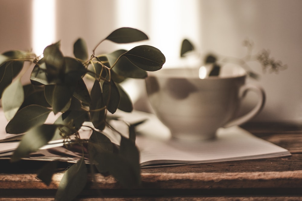 a cup of coffee sitting on top of a wooden table