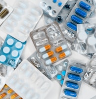 a pile of pills sitting next to each other on top of a table