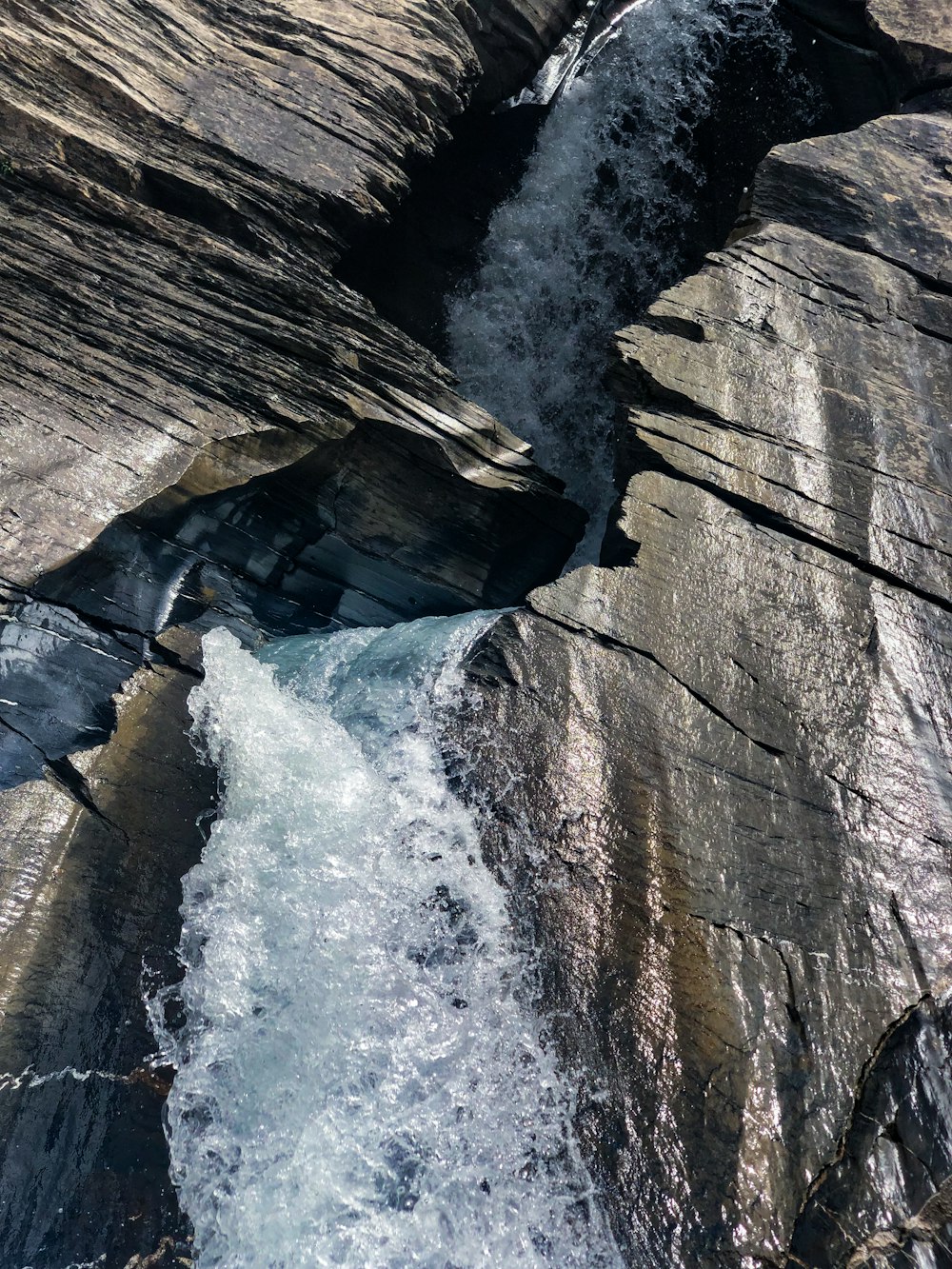 a stream of water running between two large rocks