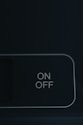 an on off button on a black wall