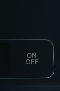 an on off button on a black wall