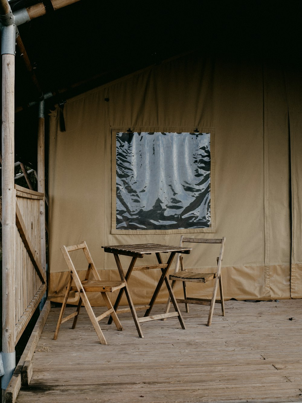 a tent with a table and chairs in front of it