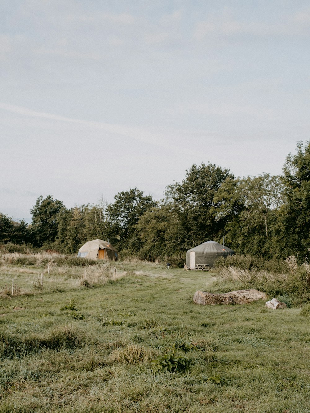 a couple of tents sitting in the middle of a field