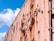 A close-up of a weathered and rusted metal surface, likely of a large container or boxcar. The paint is peeling off, revealing rust underneath. The words 'REFRIGERATION' are partially visible on the side. The sky is bright blue with some fluffy white clouds.