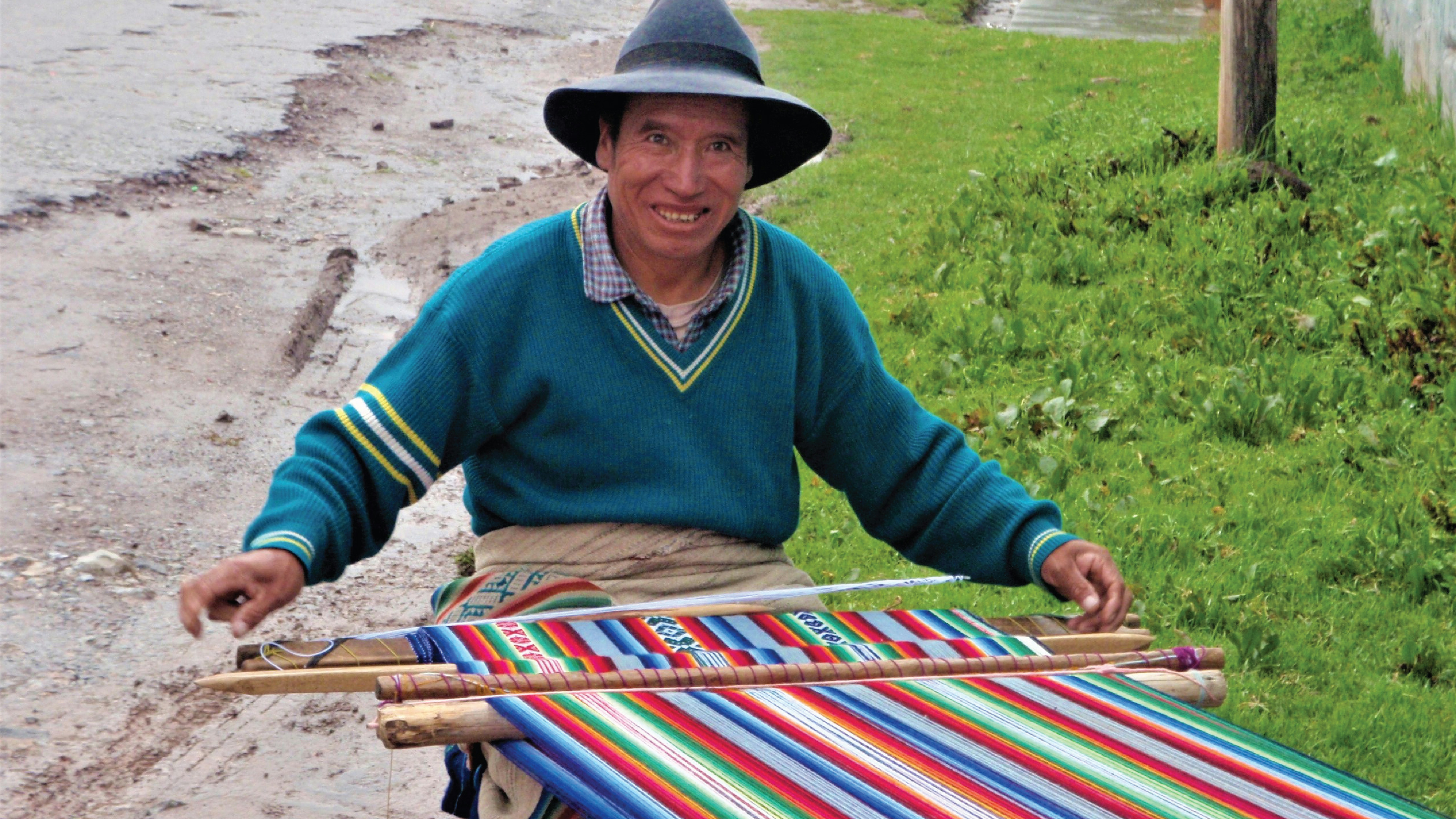 Latin American worker weaving alpaca wool textiles by hand