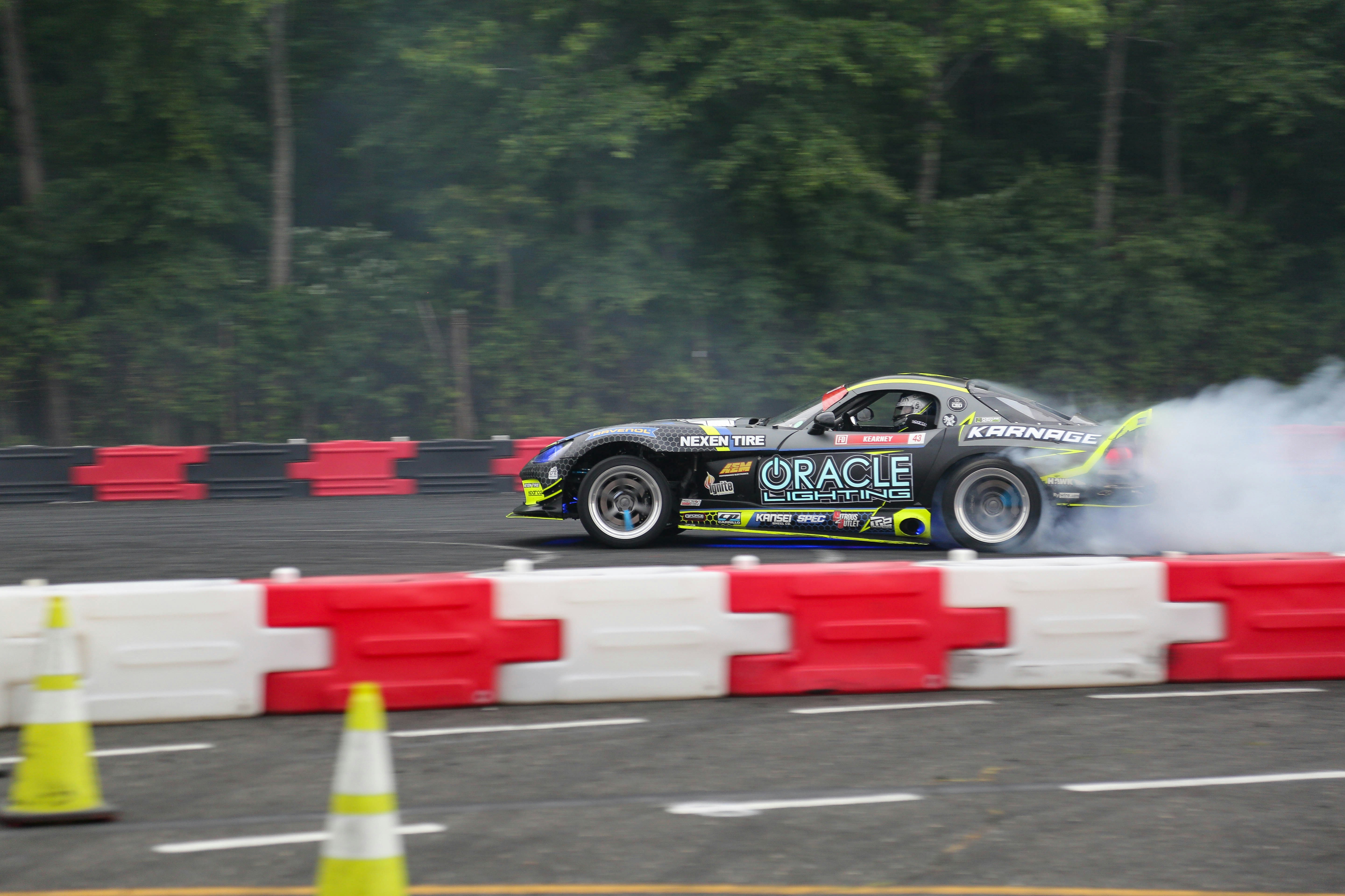 a car with smoke coming out of it on a race track