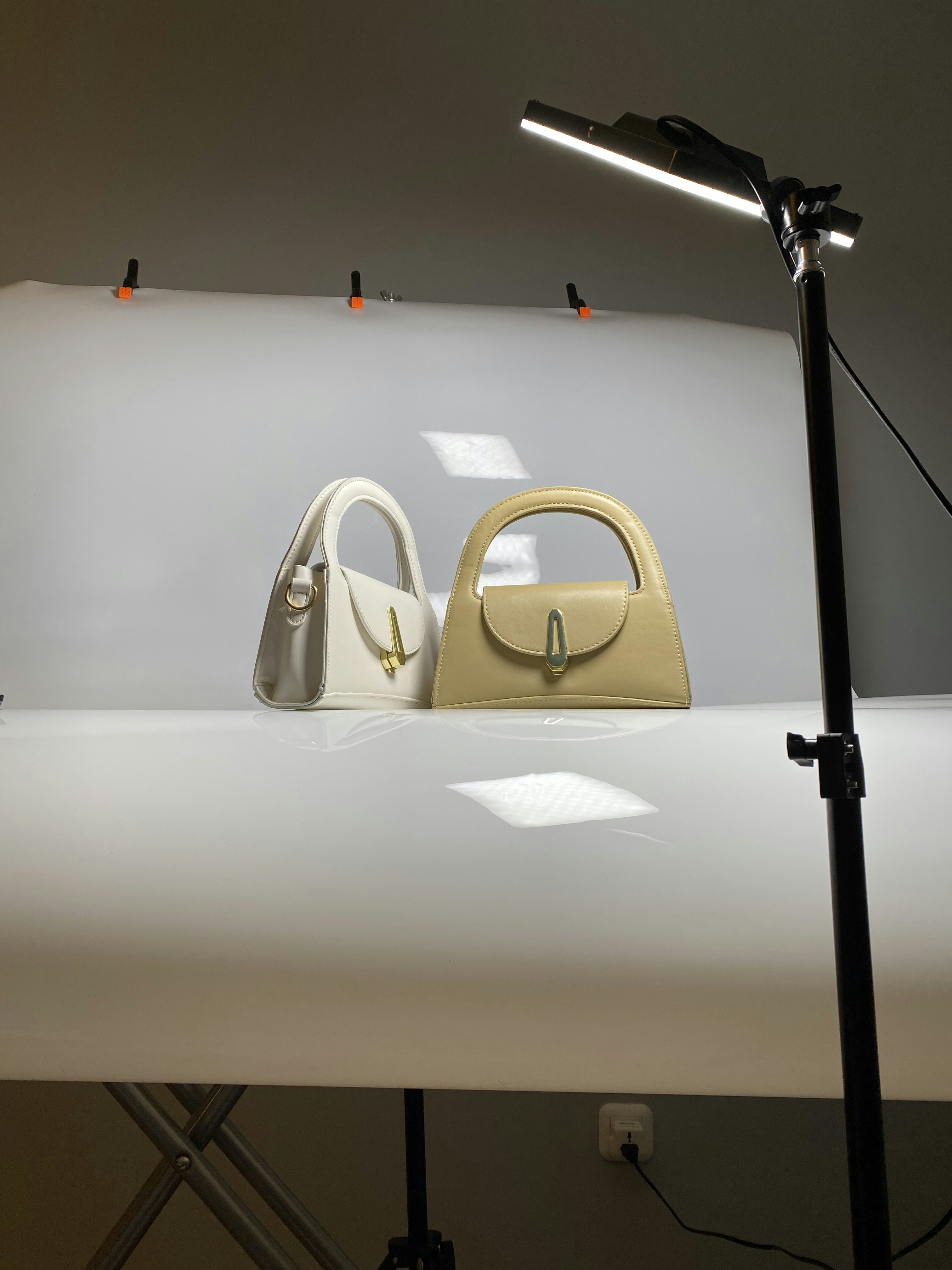 a pair of purses sitting on top of a white table