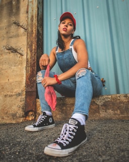 a woman sitting on the ground with her legs crossed