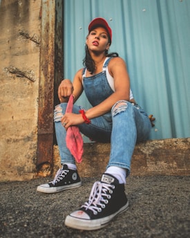 a woman sitting on the ground with her legs crossed