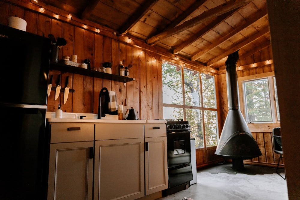 a kitchen with a stove top oven next to a window