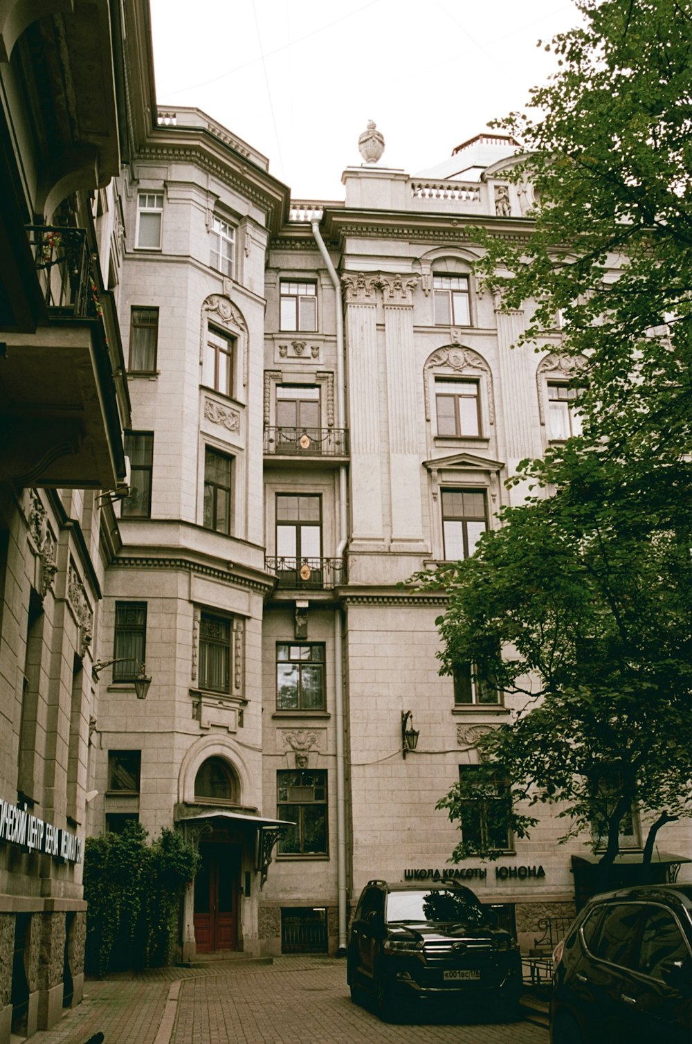 a large building with many windows and a red door