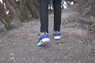 A person walking on a path wearing comfortable footwear.