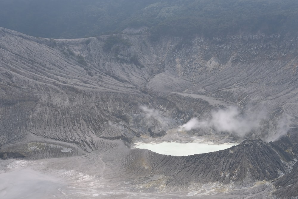 a large crater with a lake in the middle of it