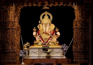 A finely carved marble idol of Lord Ganesha with intricate detailing.