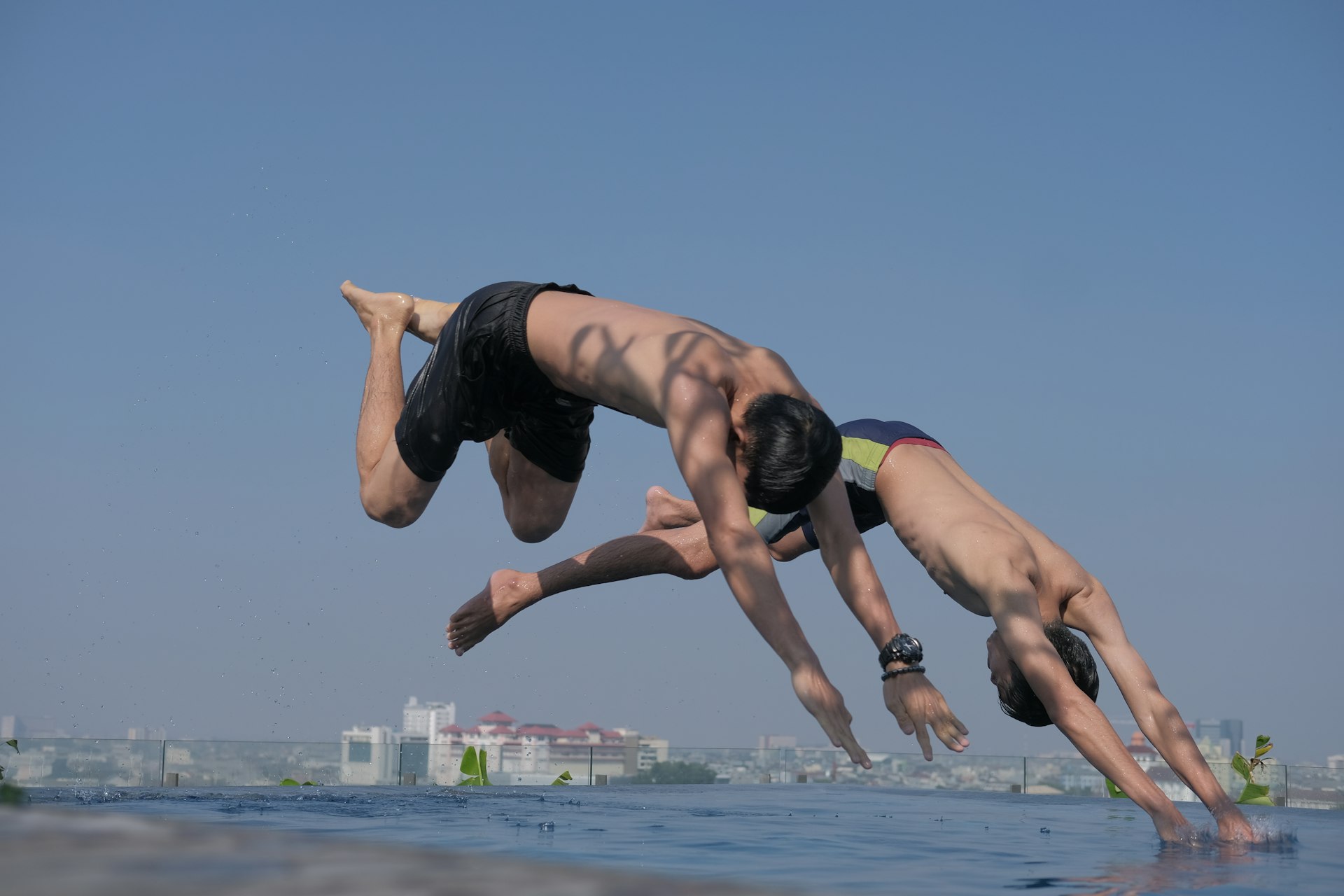 two men diving into a body of water