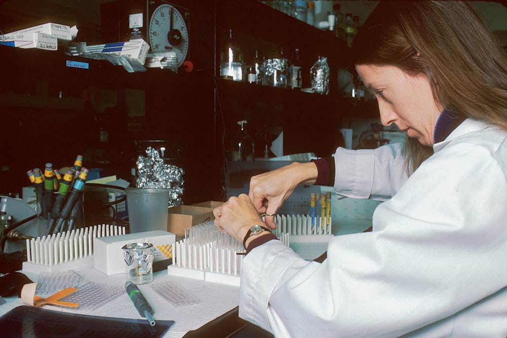 a woman in a lab coat is doing something