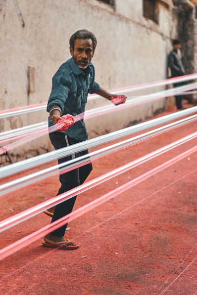 a man holding a pair of pink gloves