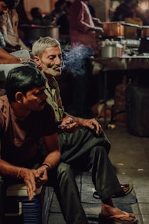 a couple of men sitting next to each other