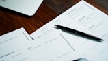 a pen sitting on top of a pile of papers