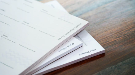 Printed assignment papers stacked