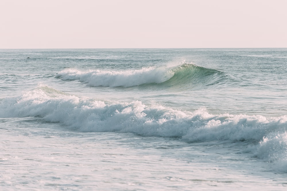 a person riding a surfboard on a wave in the ocean