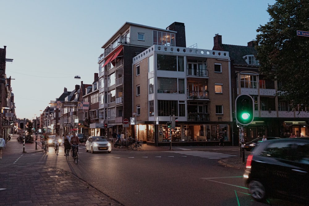 a group of people walking down a street next to tall buildings