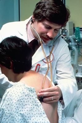 a doctor examining a woman's chest with a stethoscope