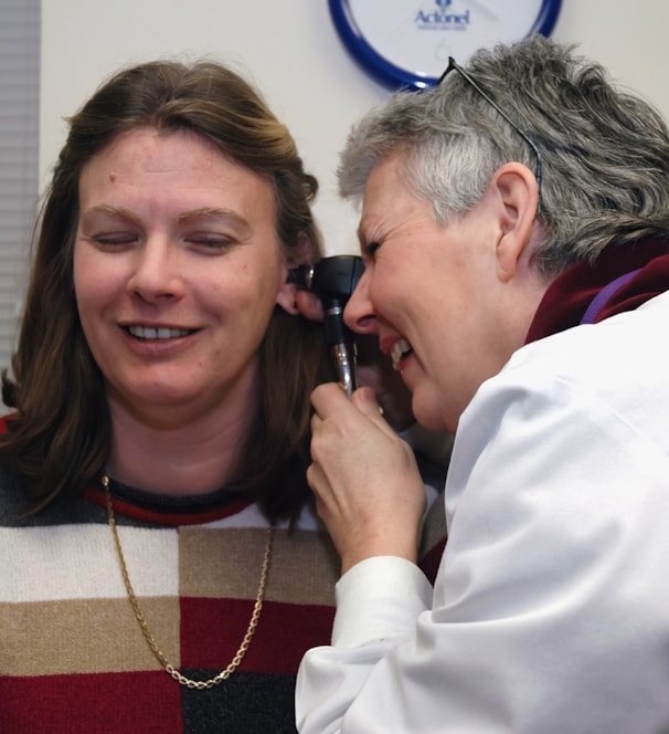 a woman talking on a cell phone next to a man