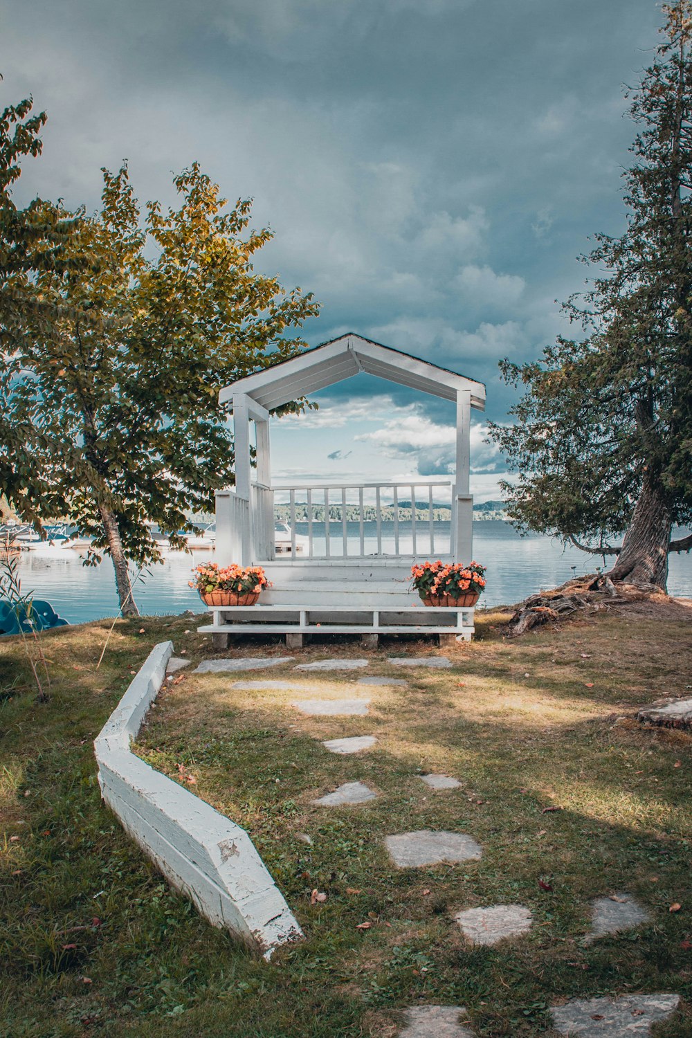 a white gazebo sitting on top of a lush green field