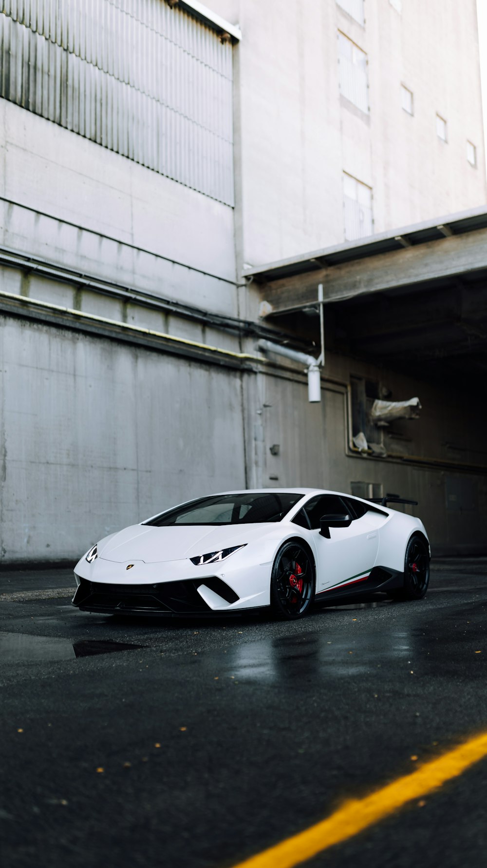 a white sports car parked in a parking lot