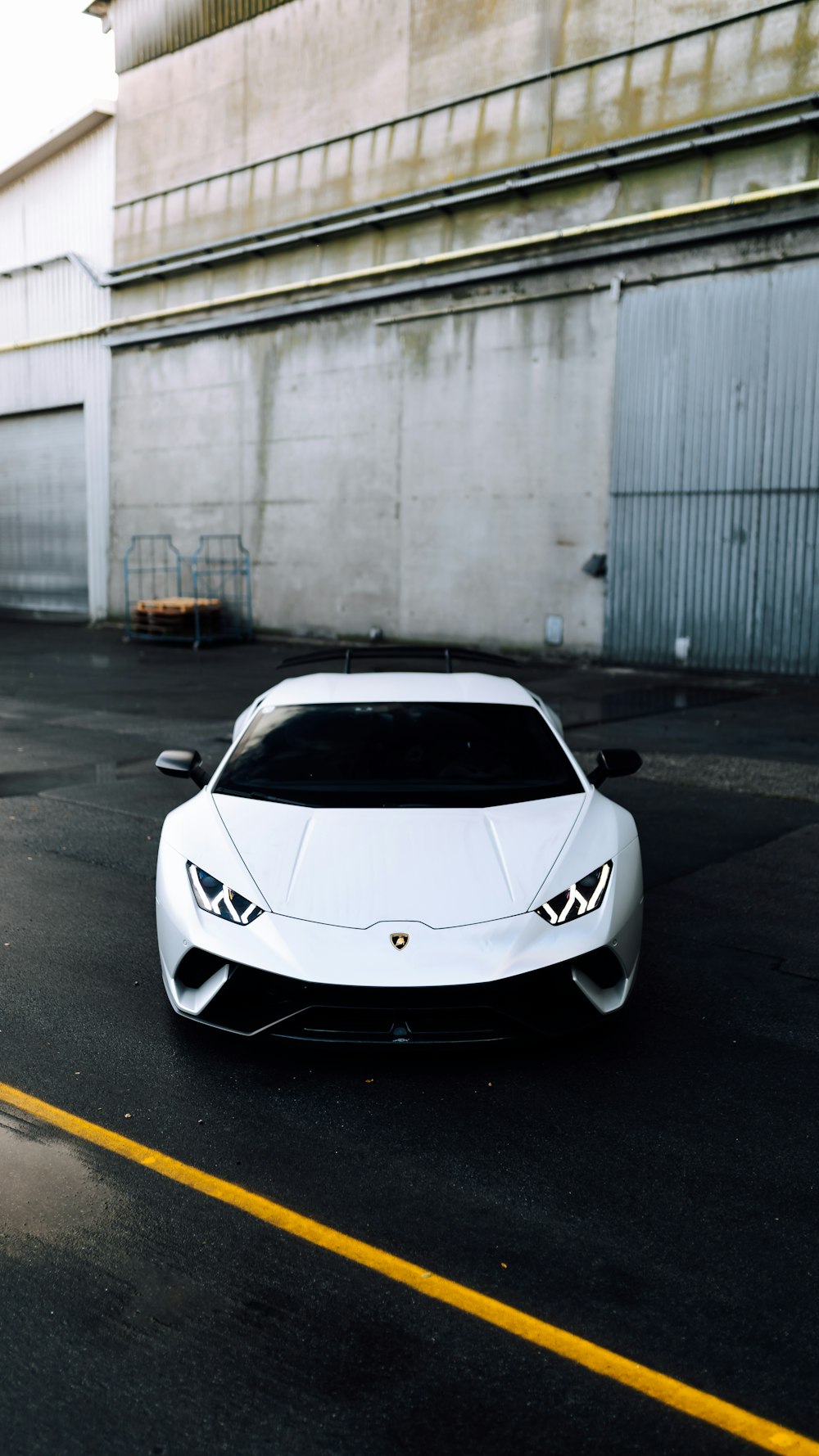 a white sports car parked in a parking lot