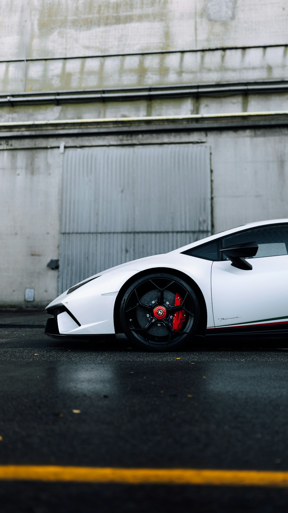 a white sports car parked in front of a building