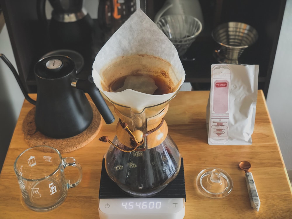 a coffee maker sitting on top of a wooden table