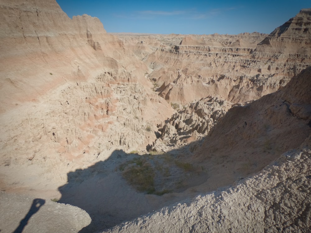 a shadow of a person standing in a canyon