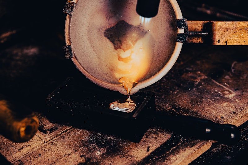 Molten gold being poured — illustrating the gold vermeil plating process used in Aega jewelry