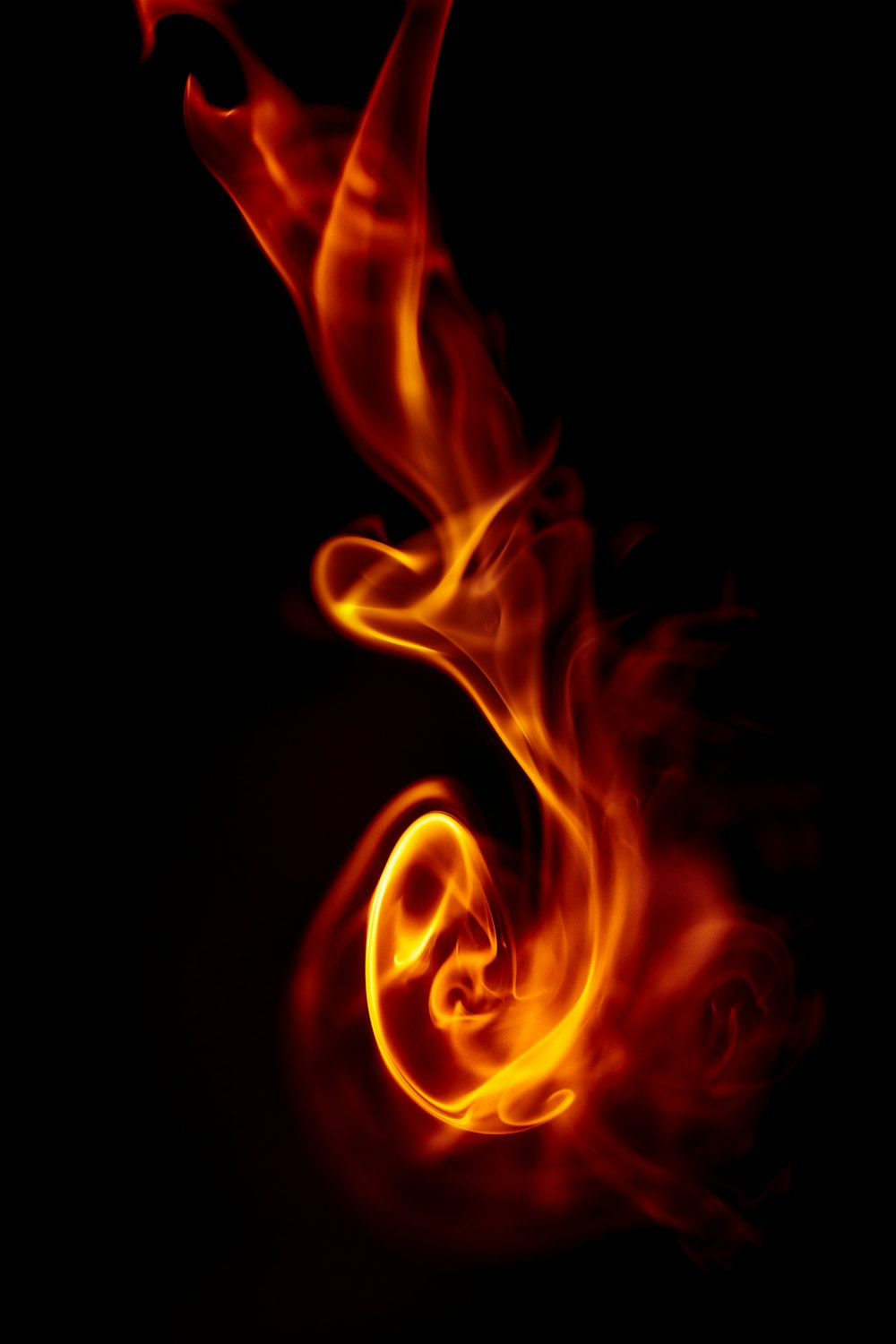 a red and yellow fire swirl on a black background
