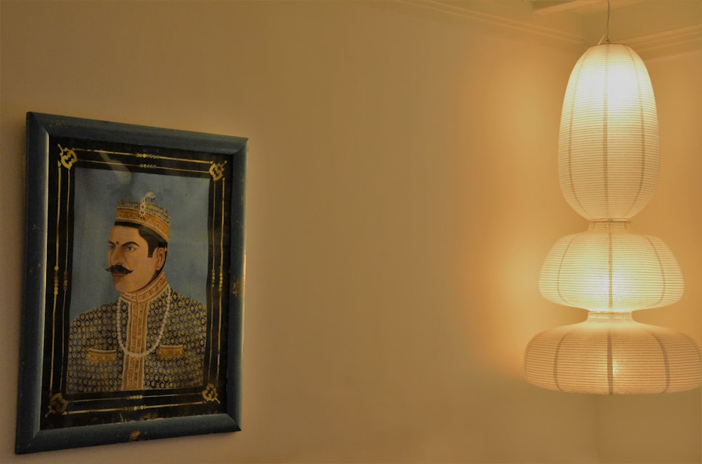 a painting of a man is hanging on the wall