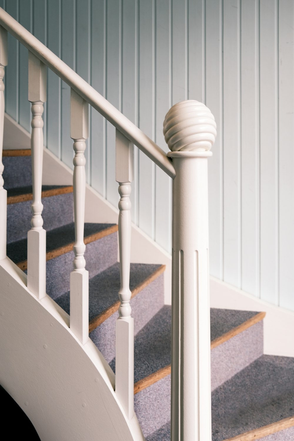 a close up of a staircase with a hand rail