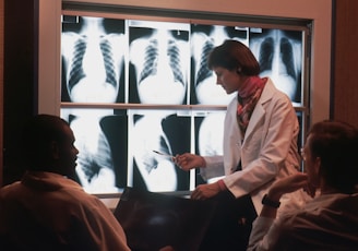 a doctor talking to a patient in front of a x - ray