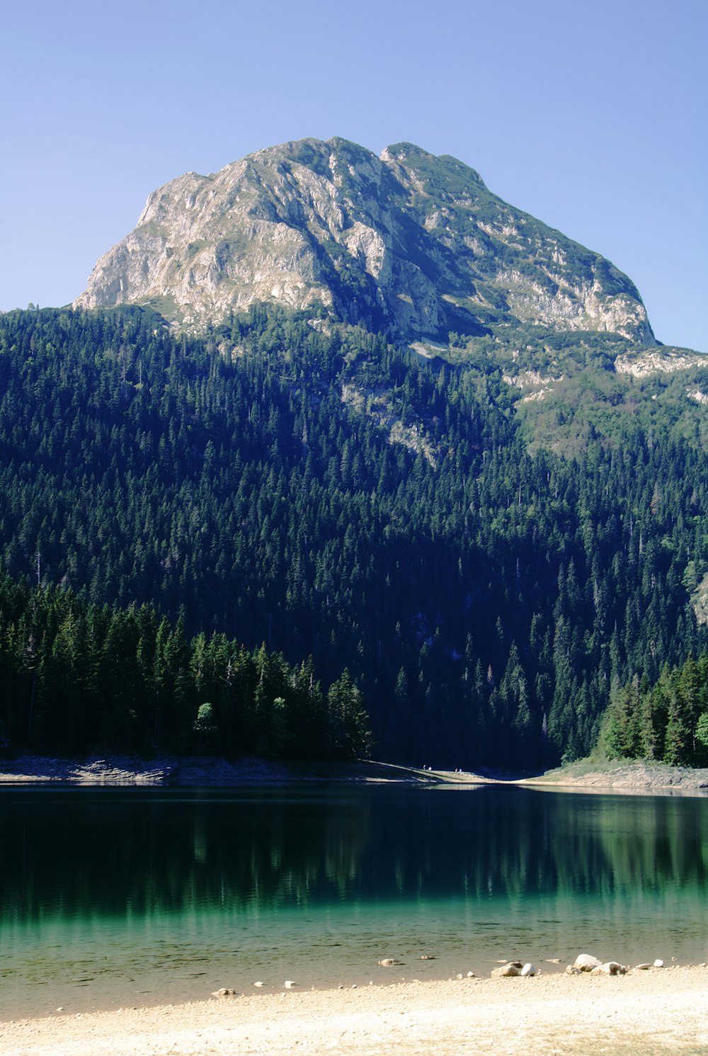 a mountain with a body of water in front of it