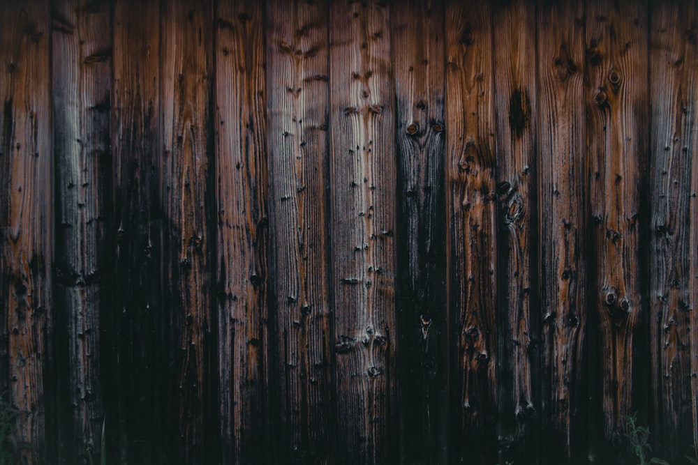 a wooden fence that is very old and rusty