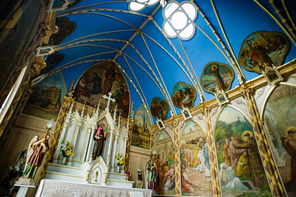 the interior of a church with paintings on the walls