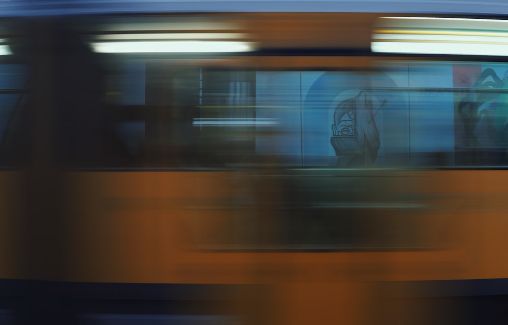 a blurry photo of a bus driving down the street