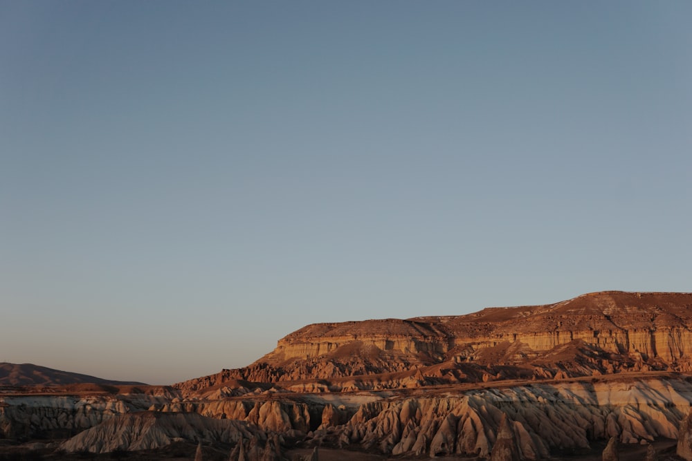 a mountain with a blue sky in the background